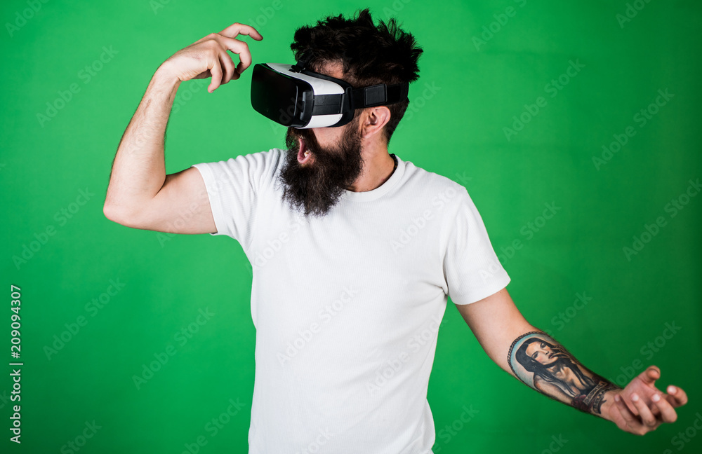 Virtual party concept. Hipster on shouting face having fun in virtual  reality. Guy with head mounted display dance in virtual reality. Man with  beard in VR glasses dancing, green background Stock Photo |