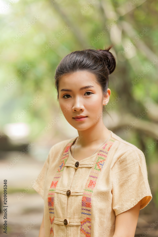 Asian woman wearing traditional Thai culture at the forest.Daily life of rural women in Thailand,Asia people at farmland. Asian woman wearing traditional Thai culture at the forest.Daily life of rural women in Thailand,Asia people at farmland.