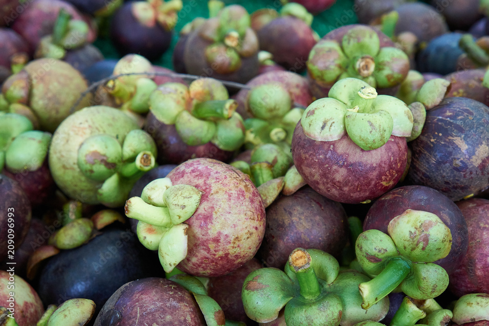 Close-up of mangosteen fruit at the pile together for sale. Close-up of mangosteen fruit at the pile together for sale.