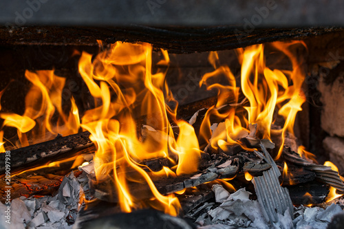 Fire inside a grill.