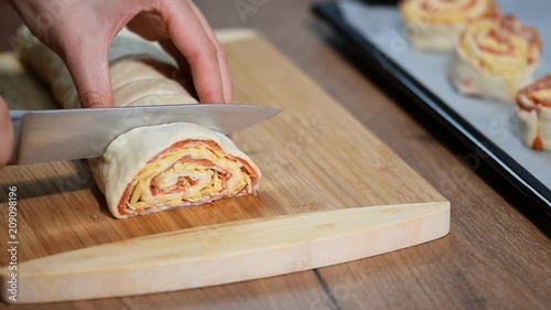 Cooking homemade Italian pizza roll on the wood table and chef. photo