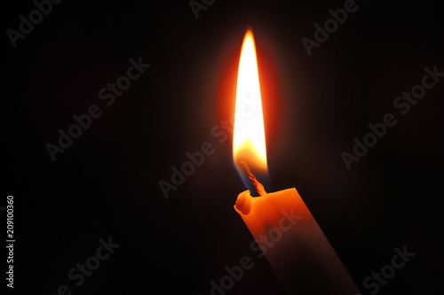 The candle is burning. Close-up
