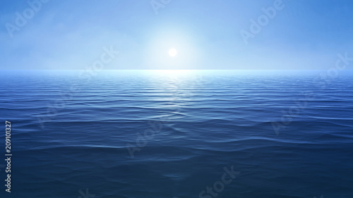 a blue ocean with sun over the horizon © magann