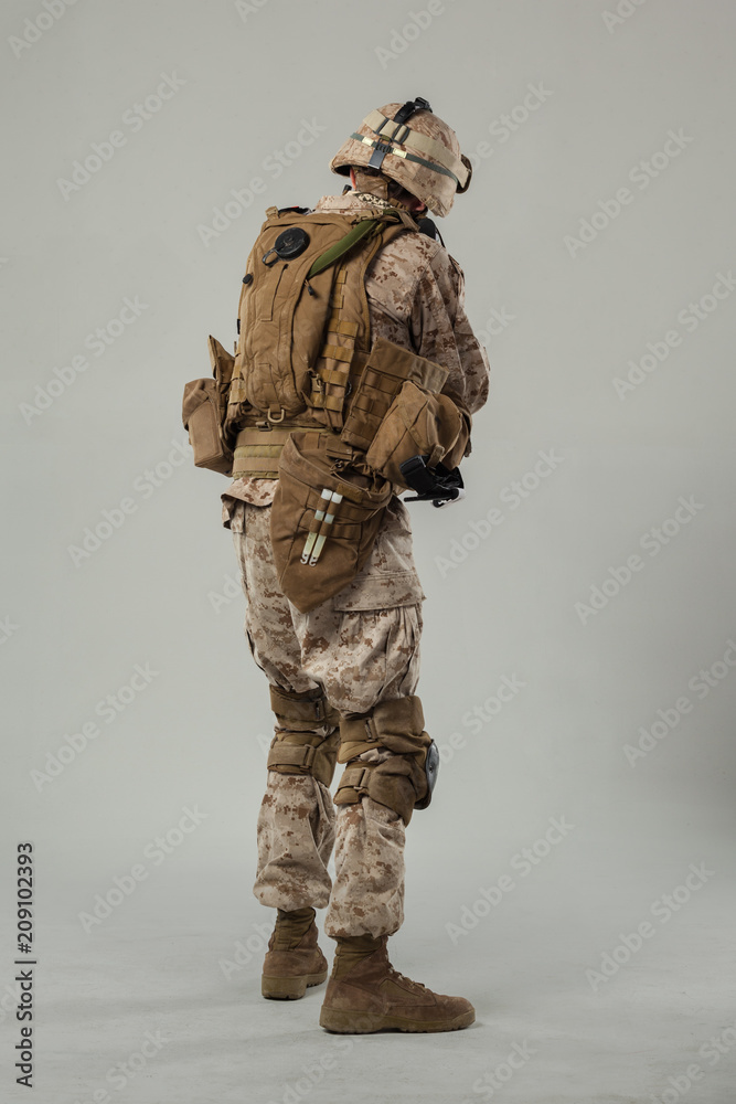 Soldier in camouflage holding rifle Soldier in camouflage holding rifle
