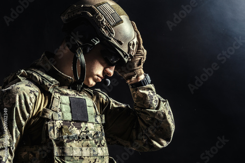 Special forces soldier with rifle on dark background