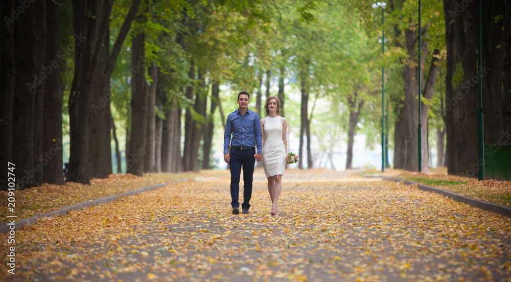 young man and woman on a walk in a park, happiness young man and woman on a walk in a park, happiness