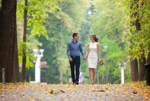 young man and woman on a walk in a park, happiness