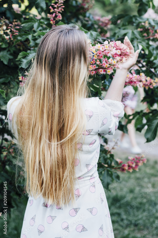 Naklejka premium girl with red chestnut flowers