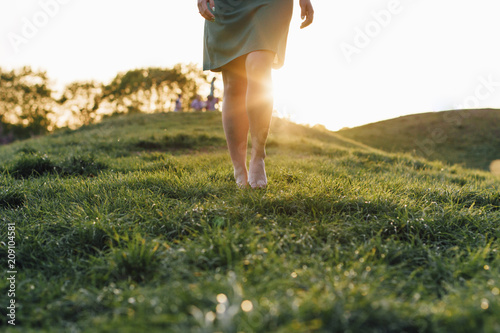  walk barefoot on the grass at sunset