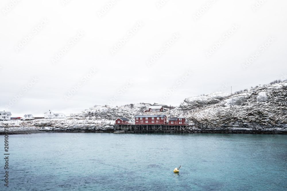 Pier of Red house located on the coast of Sakrisoy Village in Lofoten Island,Norway / Winter time 