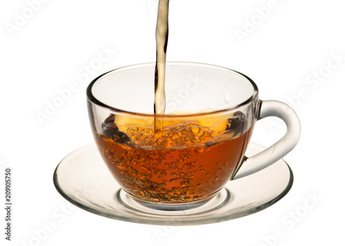 a jet of tea flows into the tea Cup, in isolation