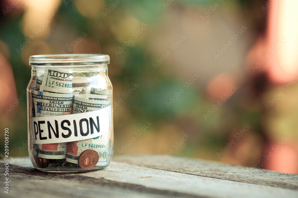 Pension word with coin in glass jar, Finance concept.