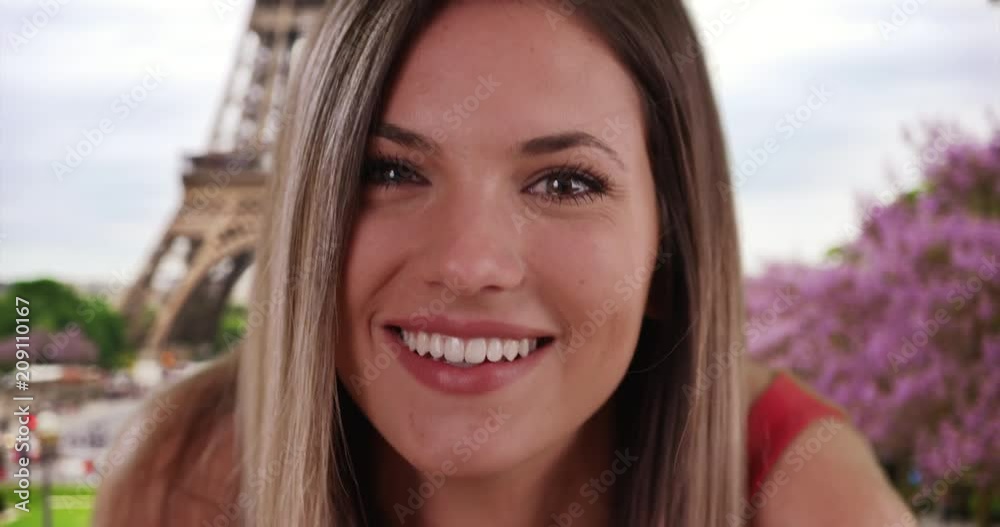 Close-up of cute millennial girl blowing kisses to camera by Eiffel Tower, Cheerful Caucasian brunette looking happily at camera while traveling in Paris, France, 4k Close-up of cute millennial girl blowing kisses to camera by Eiffel Tower, Cheerful Caucasian brunette looking happily at camera while traveling in Paris, France, 4k
