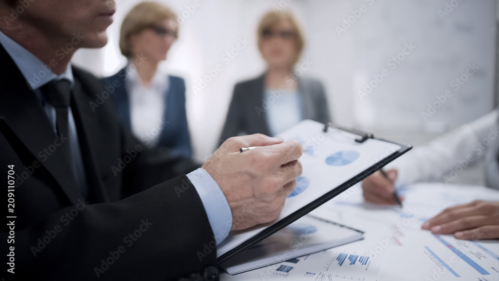 Company management analyzing statistics charts and sharing ideas about plans Company management analyzing statistics charts and sharing ideas about plans