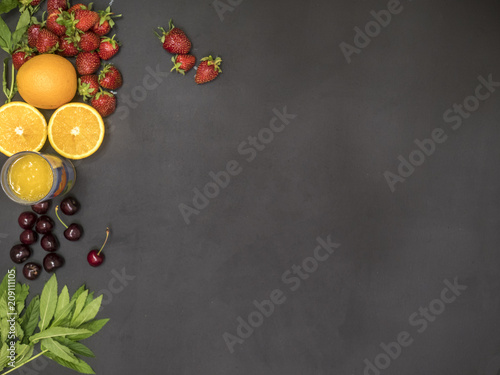 overhead flat lay of fresh raw mint cherry orange juice glass and strawberry with copy space mockup