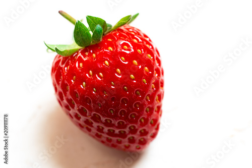 Single red delicious strawberry