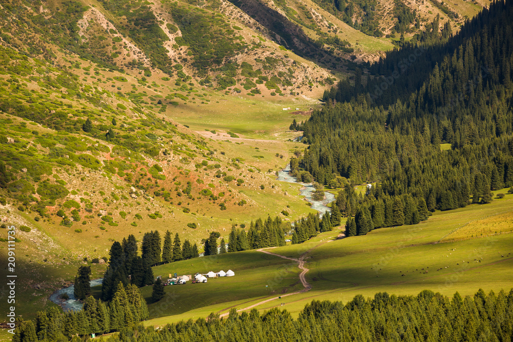 Green sunny glade and campground. The valley Jeti oguz. Kyrgyzstan.