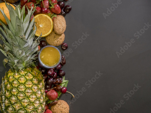 fresh raw fruits cookies and juice on a black board overhead copy space mockup