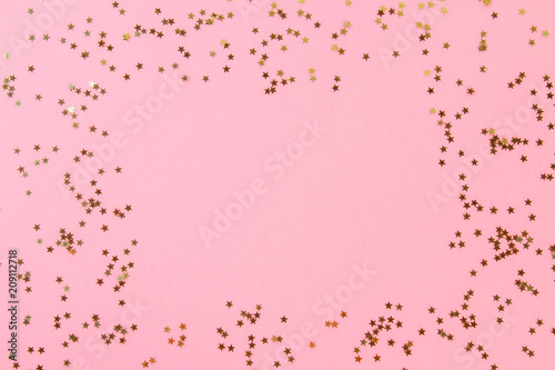 Empty space on a pastel background surrounded by shiny decorative stars and balls.