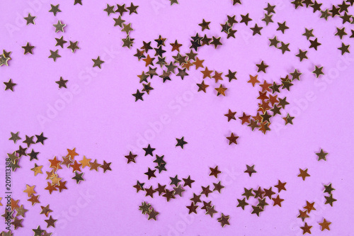 Pastel background decorated with shiny decorative stars and balls.