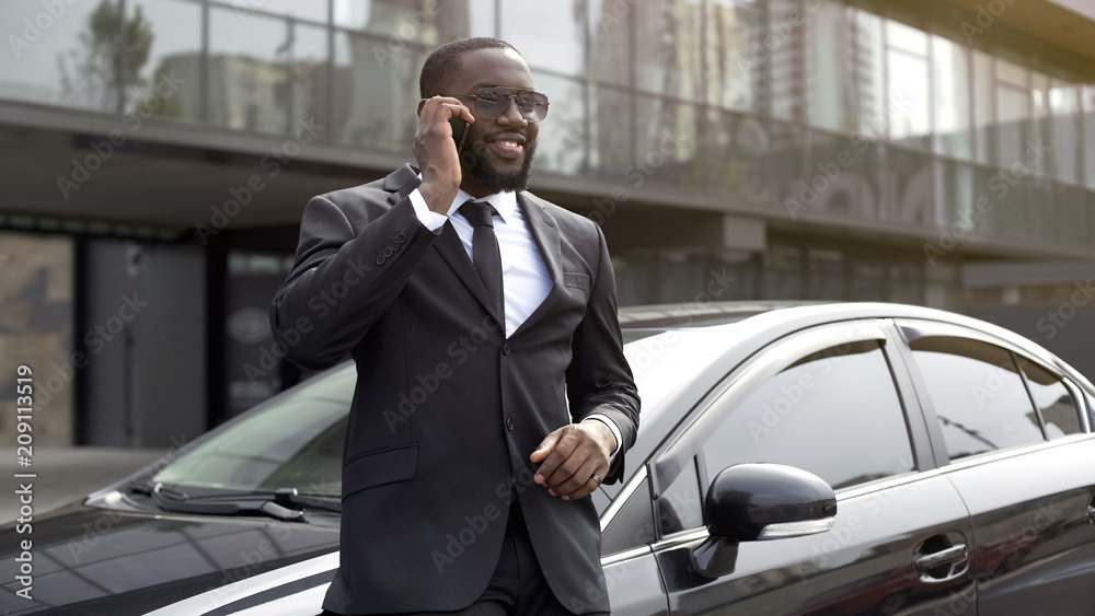 Successful employee talking on phone to boss, telling about business meeting Successful employee talking on phone to boss, telling about business meeting