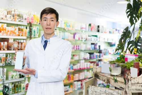 man pharmacist is standing with medicine