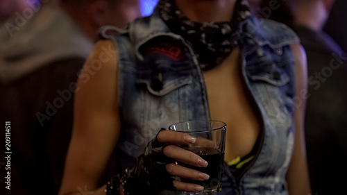 Woman with drink open for new friends looking for date in local bar, nightlife
