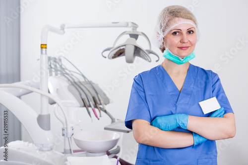 Woman dentist with arms crossed at clinic