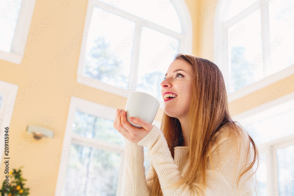 Happy young woman drinking coffee at home Happy young woman drinking coffee at home