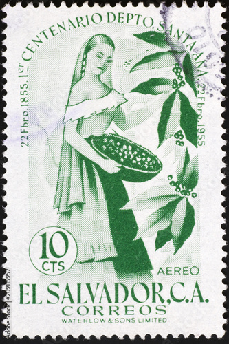 Woman collecting coffee berries on stamp of El Salvador