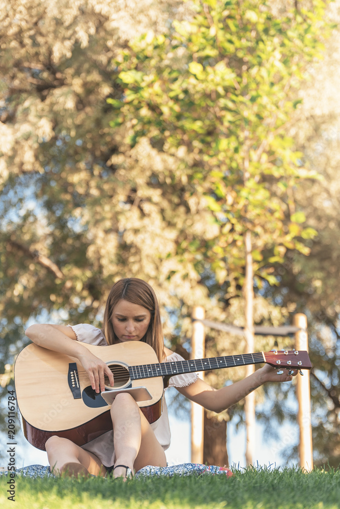 Beautiful woman playing guitar.