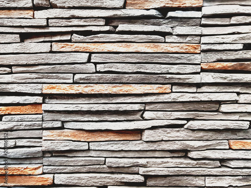 Stone wall texture, slim briks.Closeup surface brick pattern at old stone brick wall textured background .