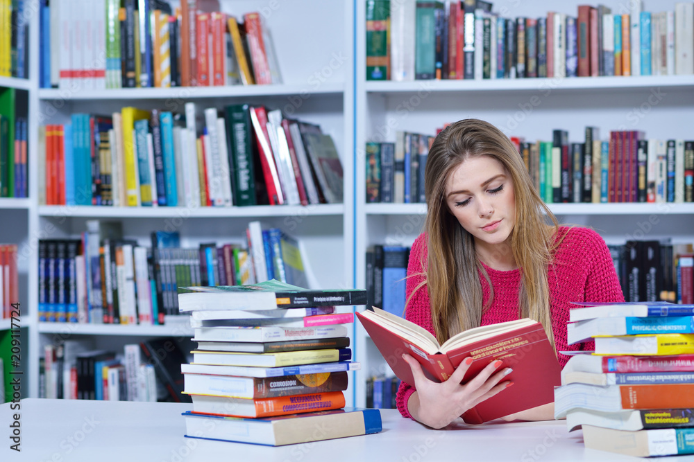Beautiful female student in a university library Beautiful female student in a university library