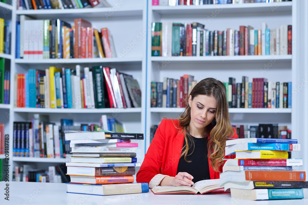 Beautiful female student in a university library Beautiful female student in a university library