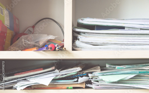 Stacks of notebooks and school supplies - a mess in the closet