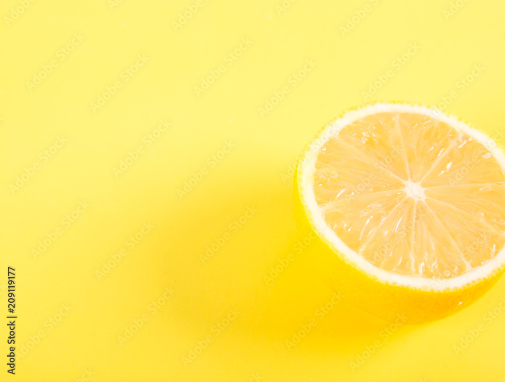 Half of lemon on a yellow background Half of lemon on a yellow background