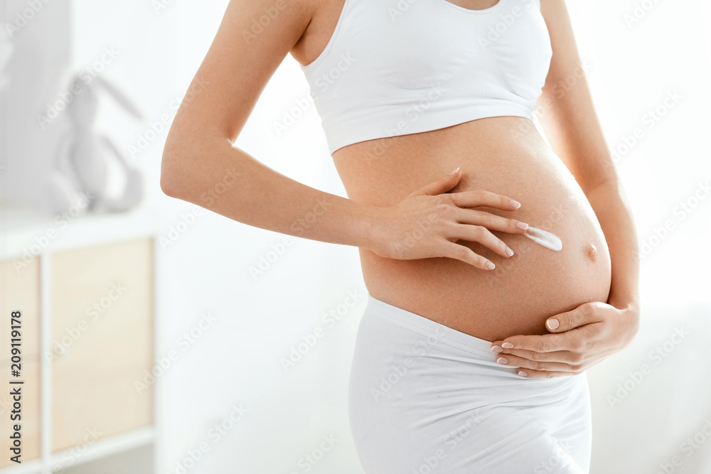 Pregnant Belly Skin Care. Belly With Cream On Skin Pregnant Belly Skin Care. Belly With Cream On Skin
