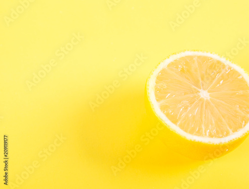 Half of lemon on a yellow background