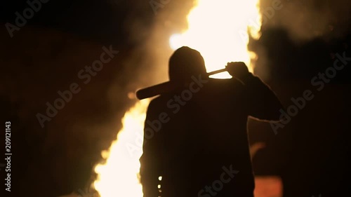 Revolution destructive behavior guy In the background is a fire. shooting at night photo