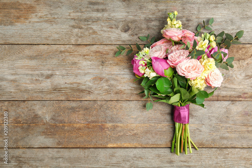 Bouquet of beautiful fragrant flowers on wooden background © New Africa