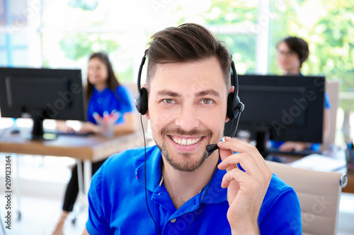 Plakat Male technical support operator with headset at workplace