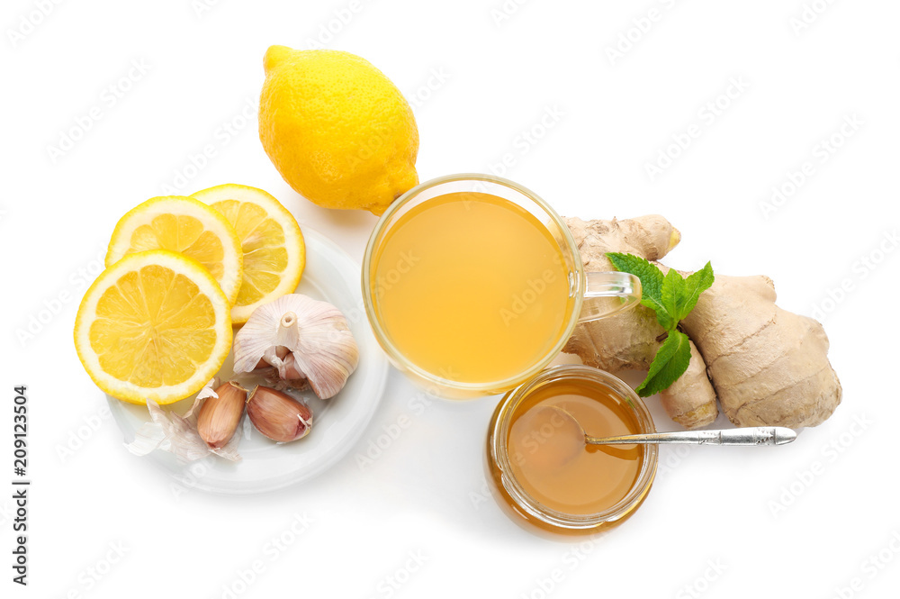 Cup with hot tea and other cold remedies on white background Cup with hot tea and other cold remedies on white background