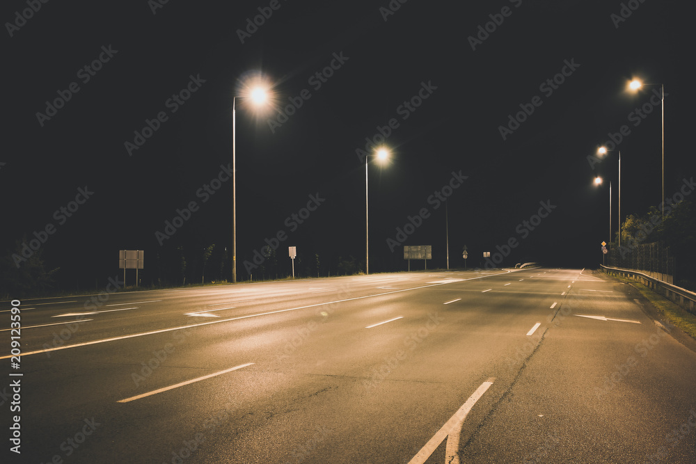 night empty highway under lanterns light concept