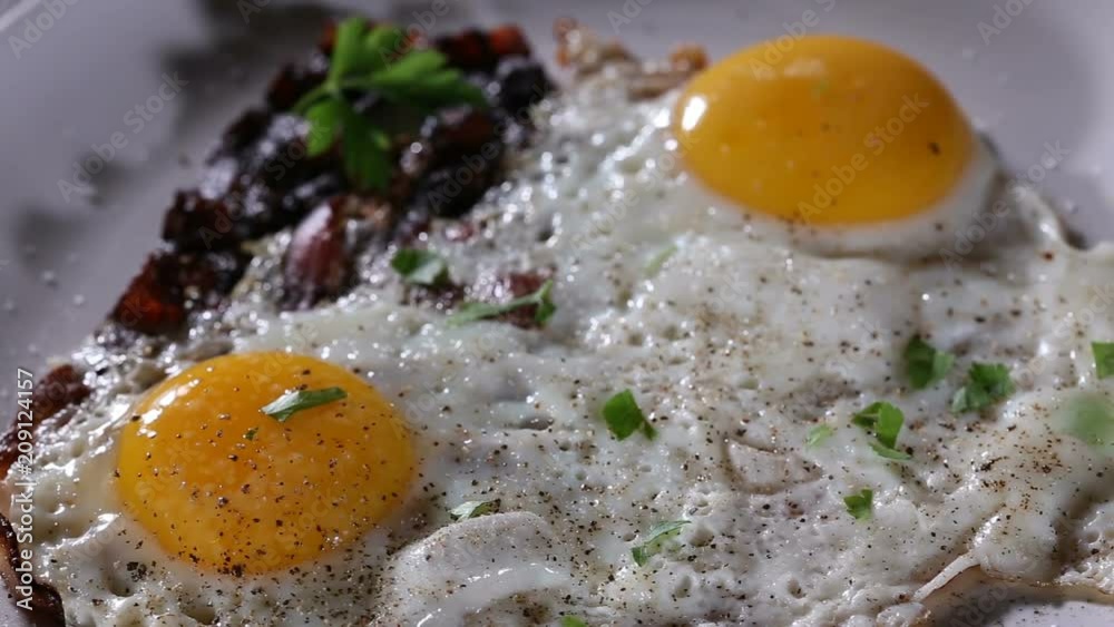 Sprinkle Chopped Green Parsley Over Fried Eggs And Bacon - Close Up View Sprinkle Chopped Green Parsley Over Fried Eggs And Bacon - Close Up View