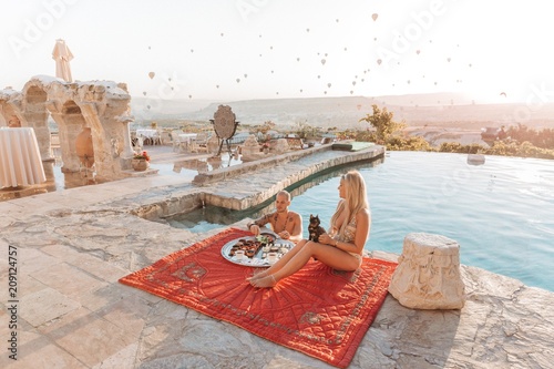 Romantic couple having breakfast at the pool in Cappadocia photo