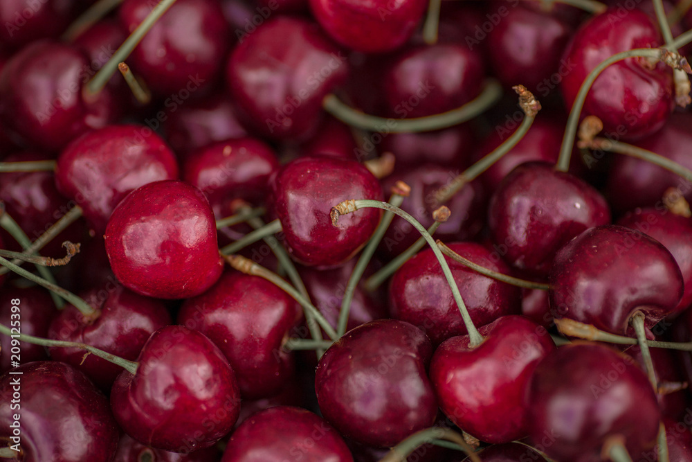 Beautiful juicy sweet cherries background. Close up of pile of ripe cherries. Minsk, Belarus. Beautiful juicy sweet cherries background. Close up of pile of ripe cherries. Minsk, Belarus.