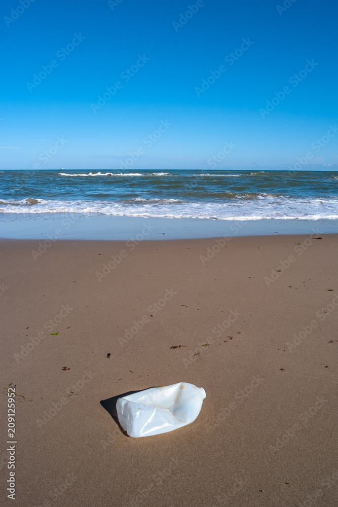 Plastic bottle in front of beautiful beach and ocean Plastic bottle in front of beautiful beach and ocean