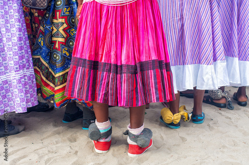 Namibian traditional dresses in pink and musical instruments on feet, Namibia, South Africa