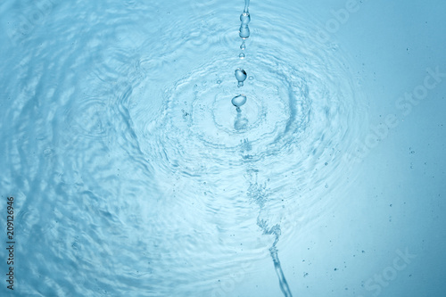 Background of blue clear water in motion with waves  pouring with splash