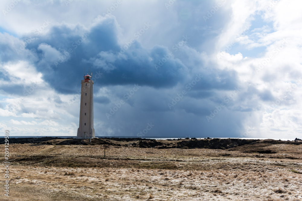 Fototapeta premium Lighthouse in front of stormy clouds in Iceland